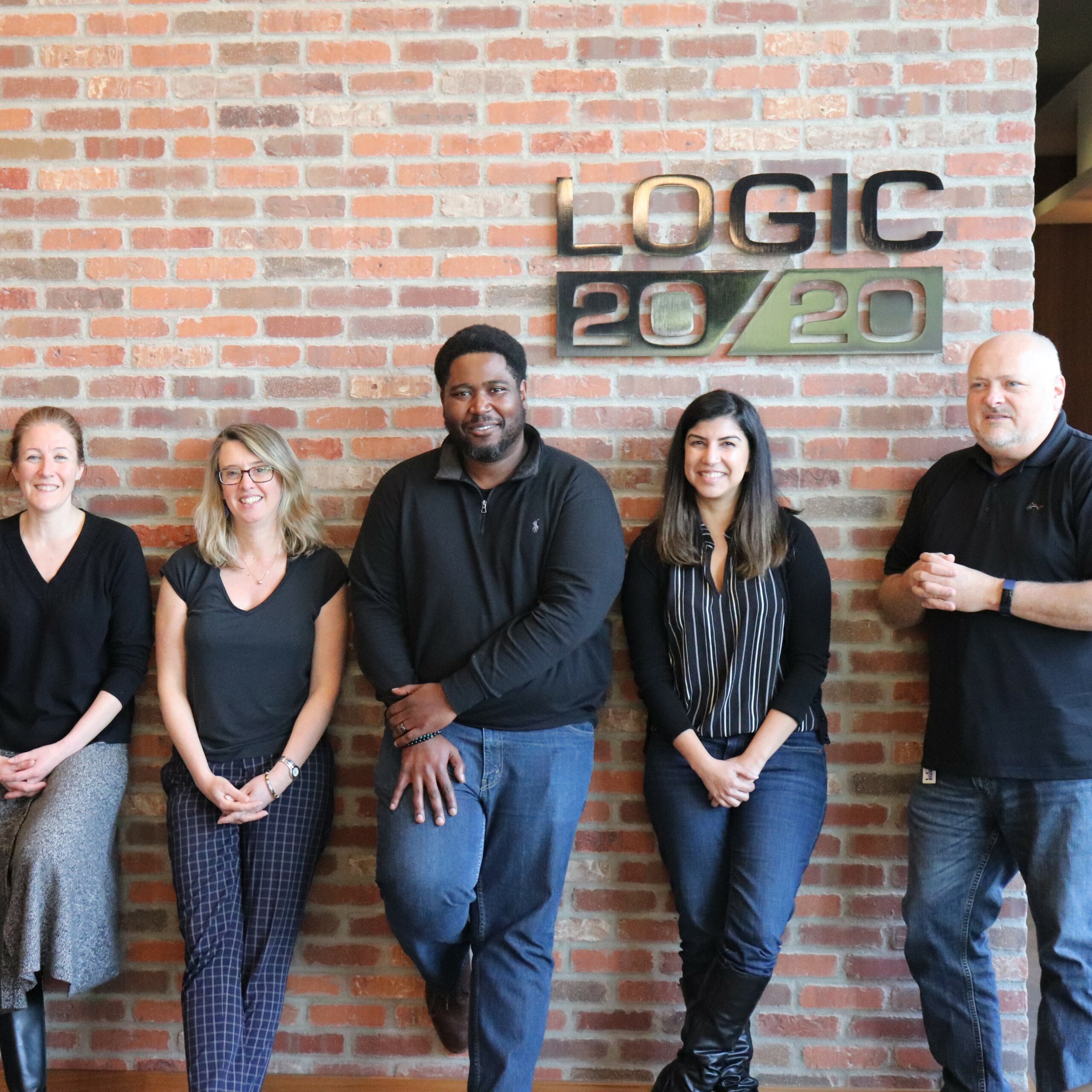 Group of People in front of brick wall