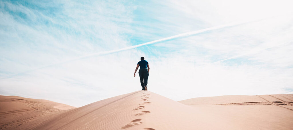Man walks through desert