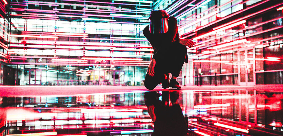 Man stands in neon alleyway