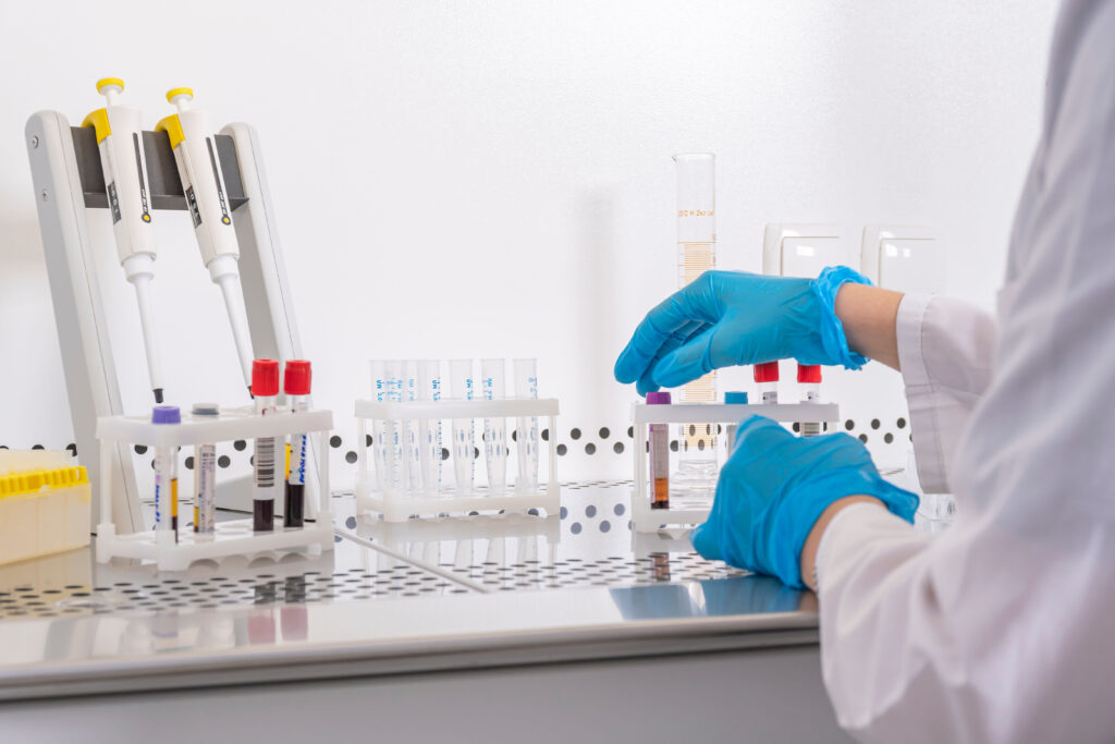 lab worker handling test tubes