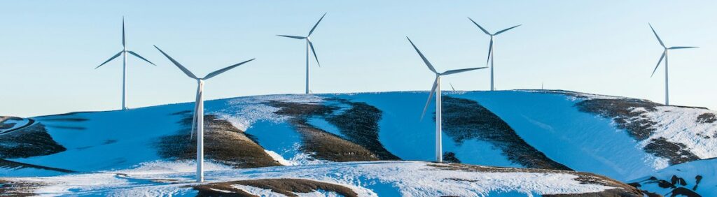 wind turbines on a snowy mountainside