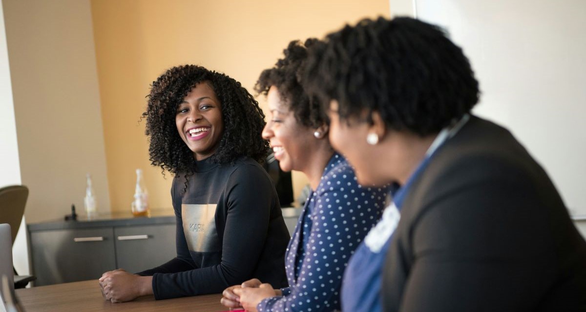 business leader meeting with team in an office setting