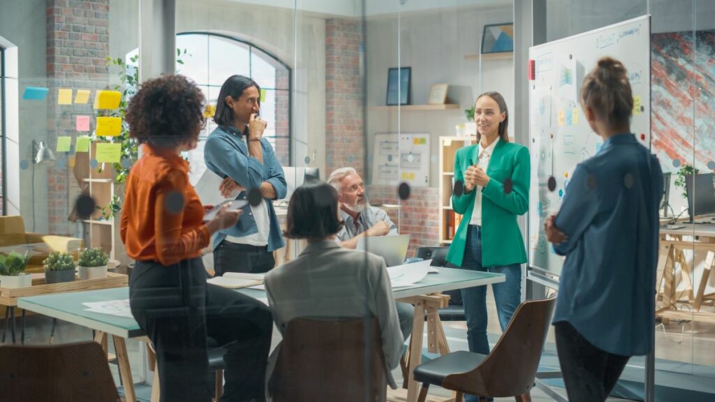 Agile team meeting in glass-walled room