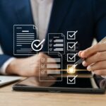 white-paper-ai-use-case-framework checklist graphics in front of man in suit sitting at a desk with a laptop and tablet