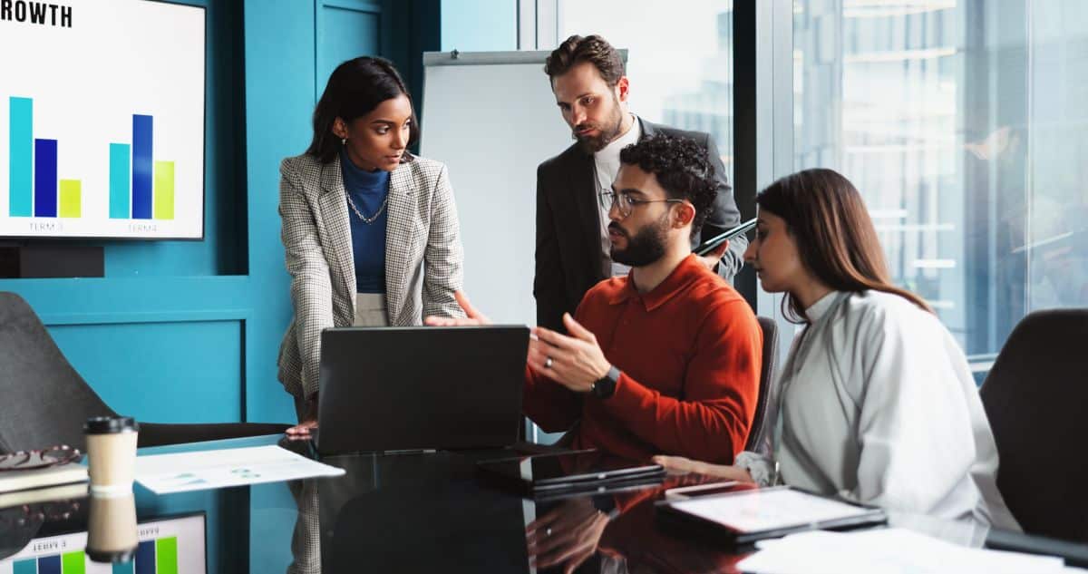 4-person team meeting in a modern office conference room