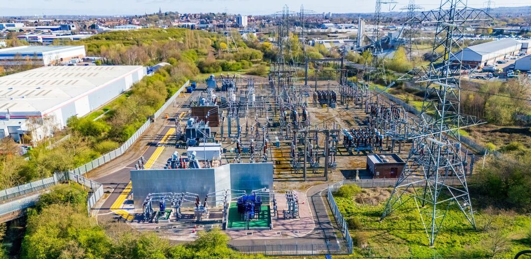 Aerial view of a modern electrical substation with transformers and insulators. Insulators, transmission line and other electrical distribution components in an electrical substation