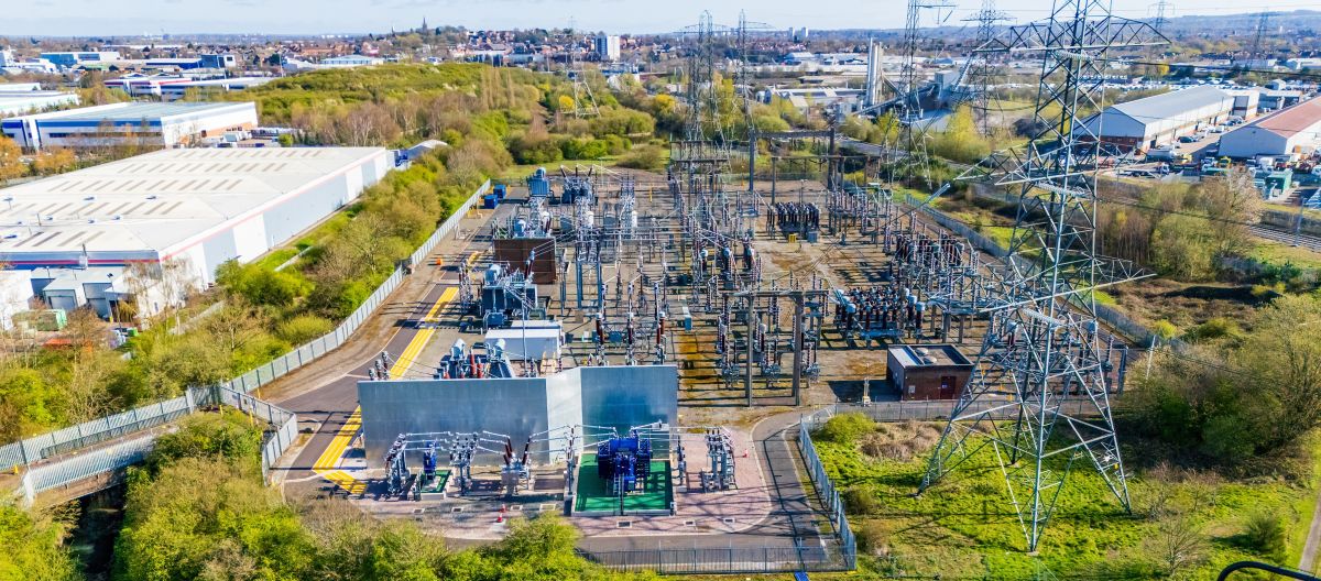 Aerial view of a modern electrical substation with transformers and insulators. Insulators, transmission line and other electrical distribution components in an electrical substation