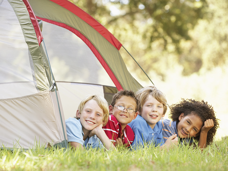 smiling kids in a camping tent