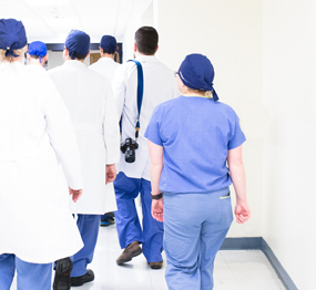 hospital staffers walking down a corridor