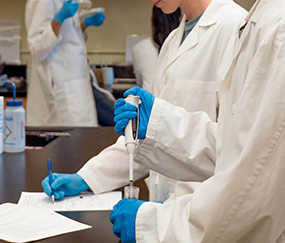 scientists in a laboratory testing a fluid