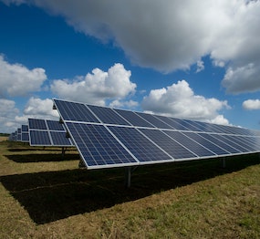 solar panels under a clouded sky